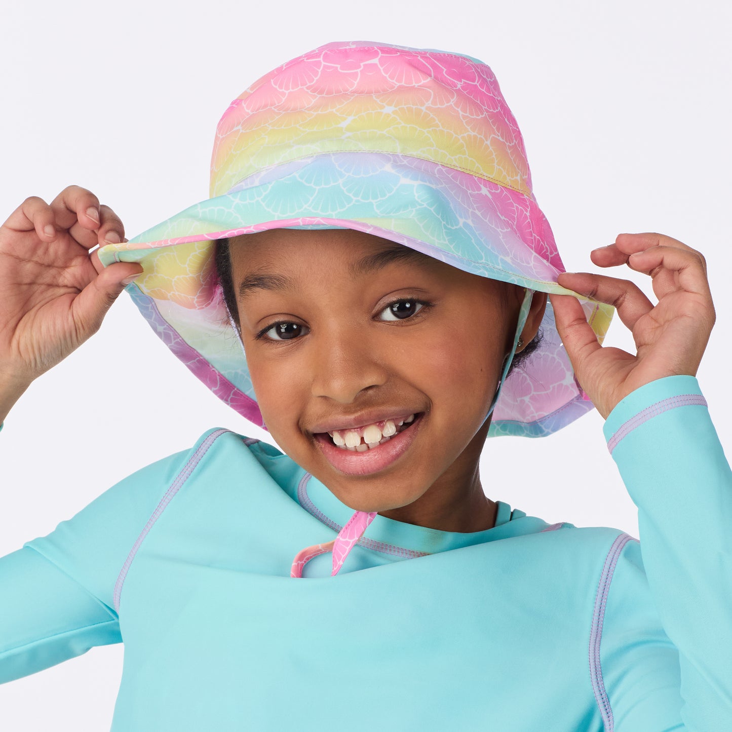 Rainbow Seashells;@A girl wearing UPF 50 Sun Hat in Rainbow Seashells
